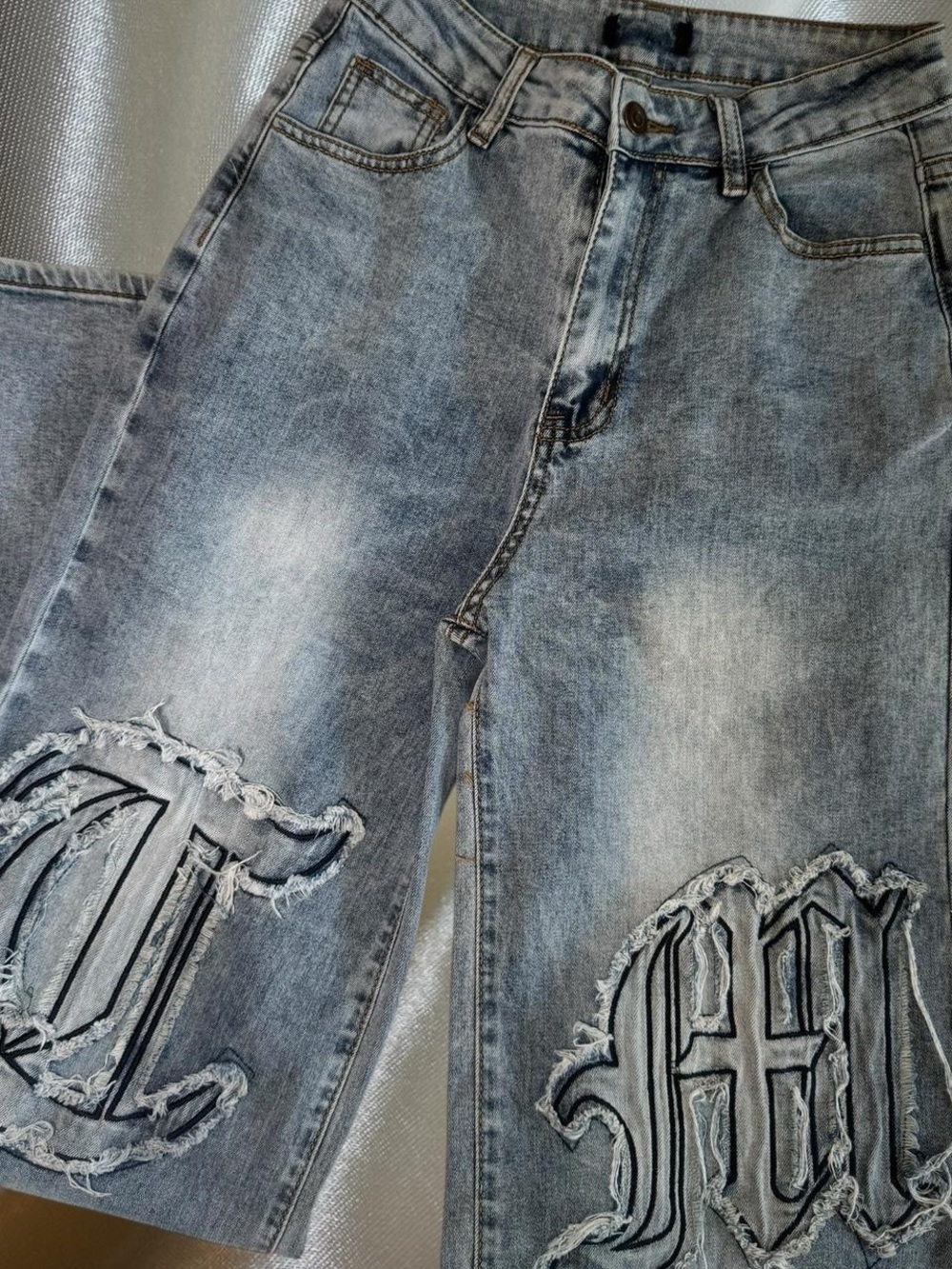 Men's Distressed Light Blue Denim Jeans with Embroidered Patch Details